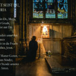 Frau betet in Kirche