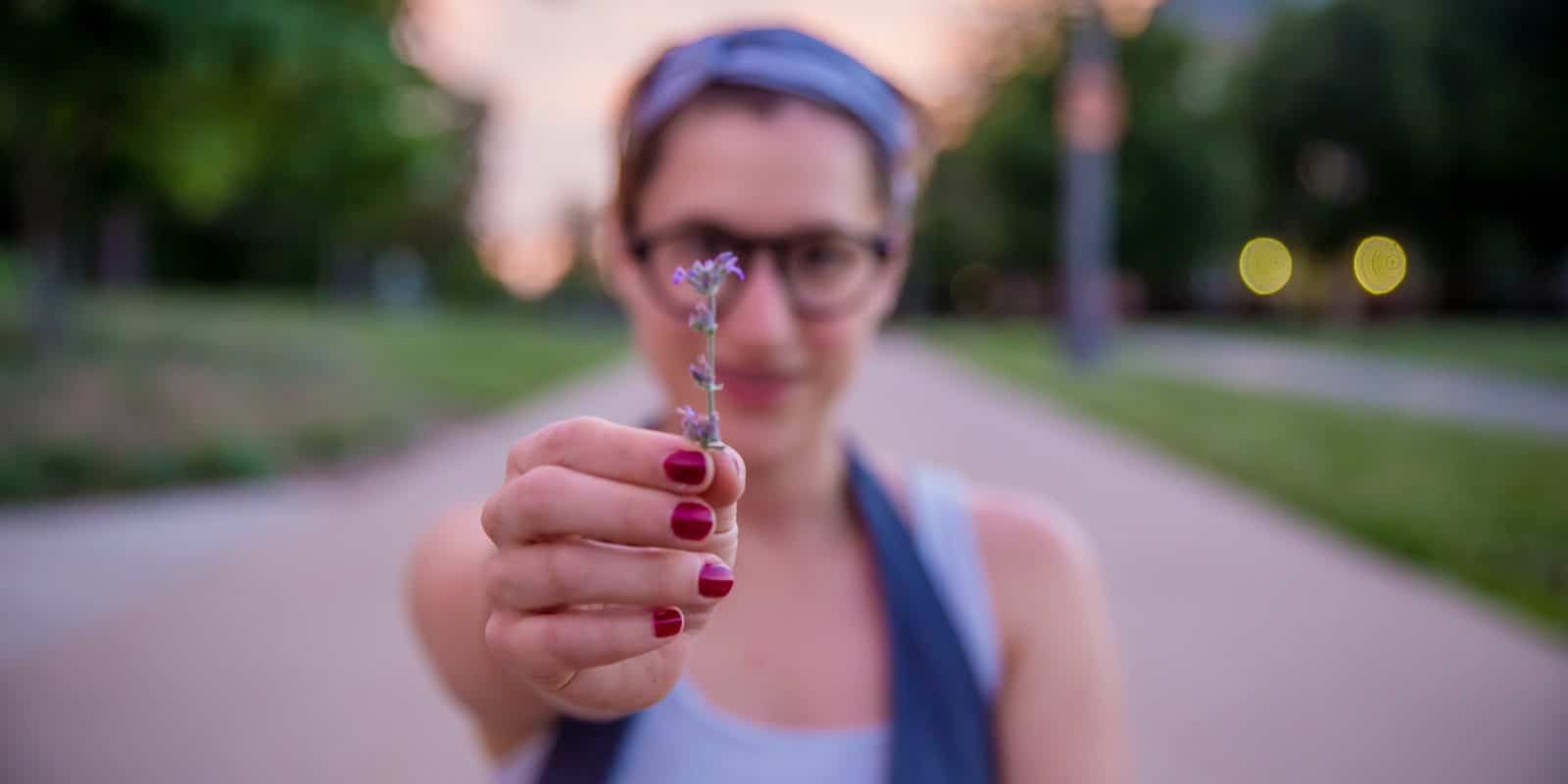 Frau hält kleine Blume