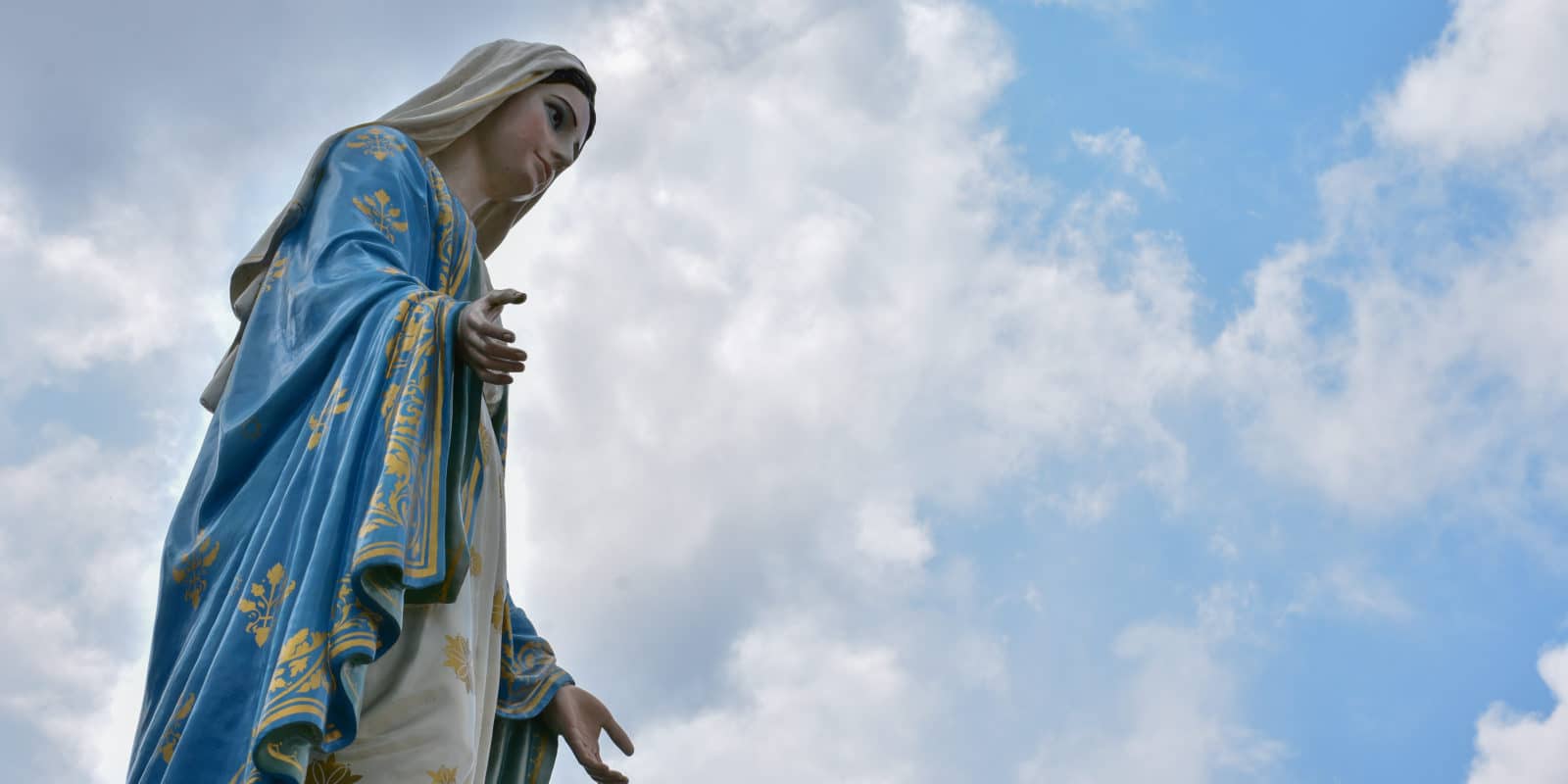 Marienstatue vor einem wolkigen Himmel